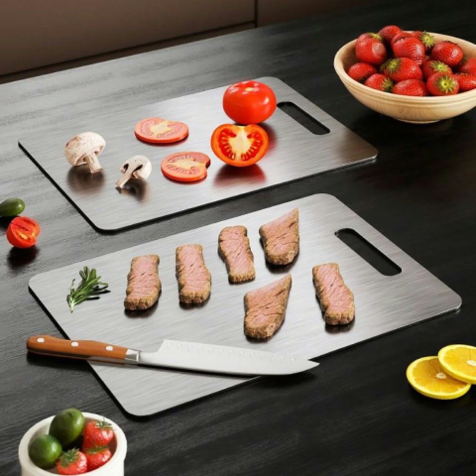 Two KatuChef titanium cutting boards with vegetables and prepared food on a kitchen worktop